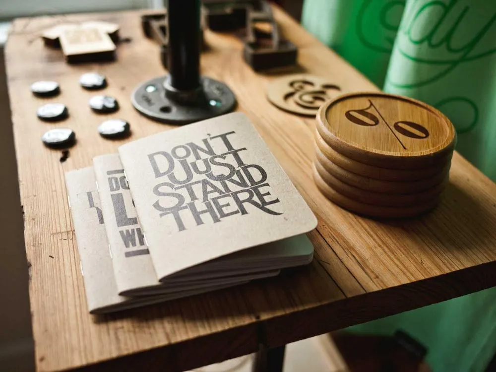 A notebook open on a desk with a bold printed phrase