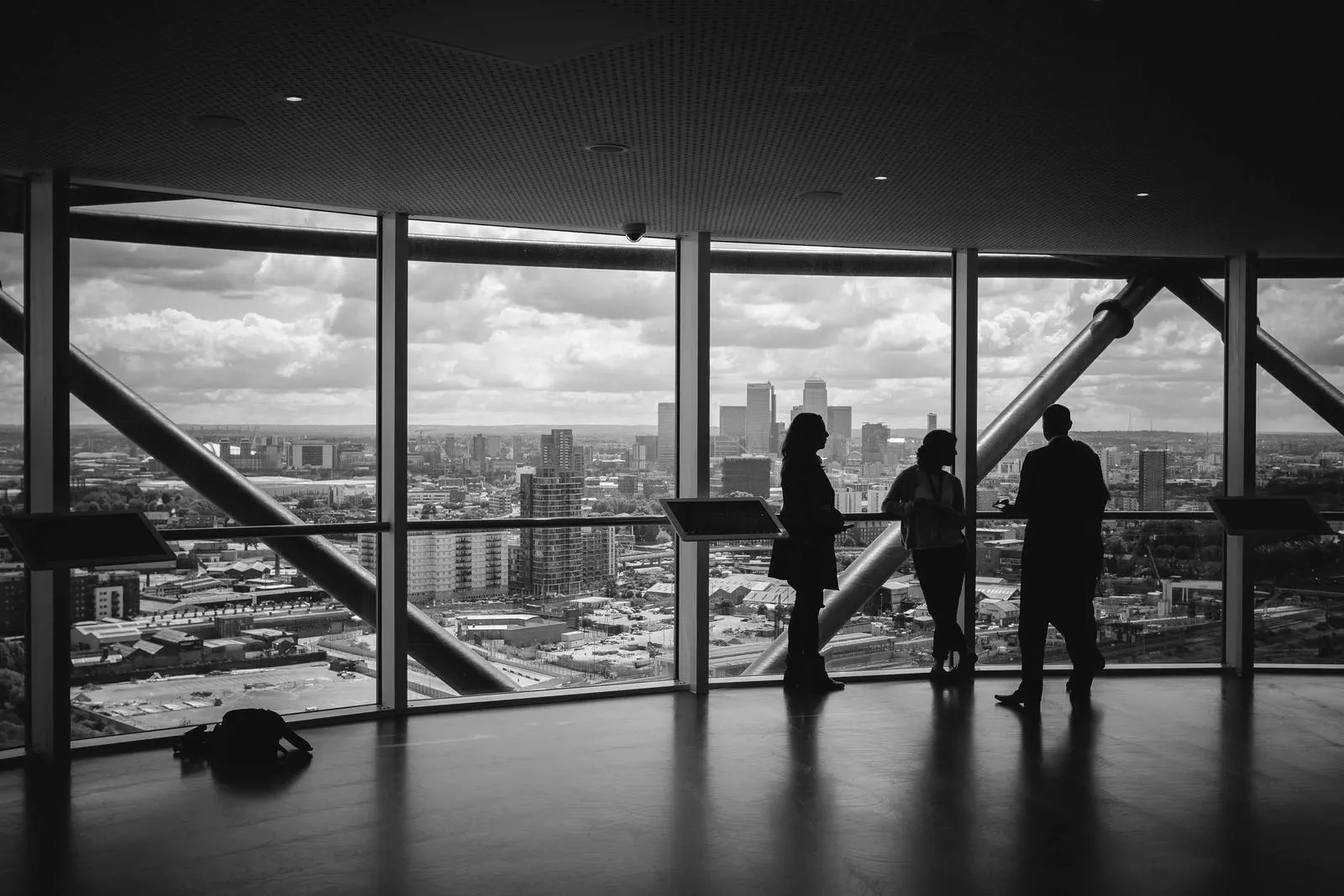 Silhouettes of a team at a window high above the city