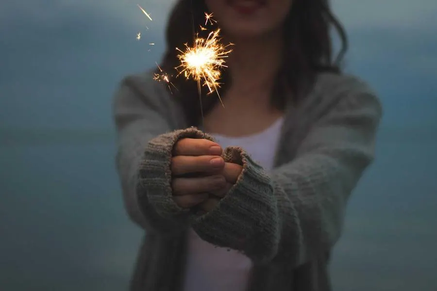 A sparkler held in cupped hands