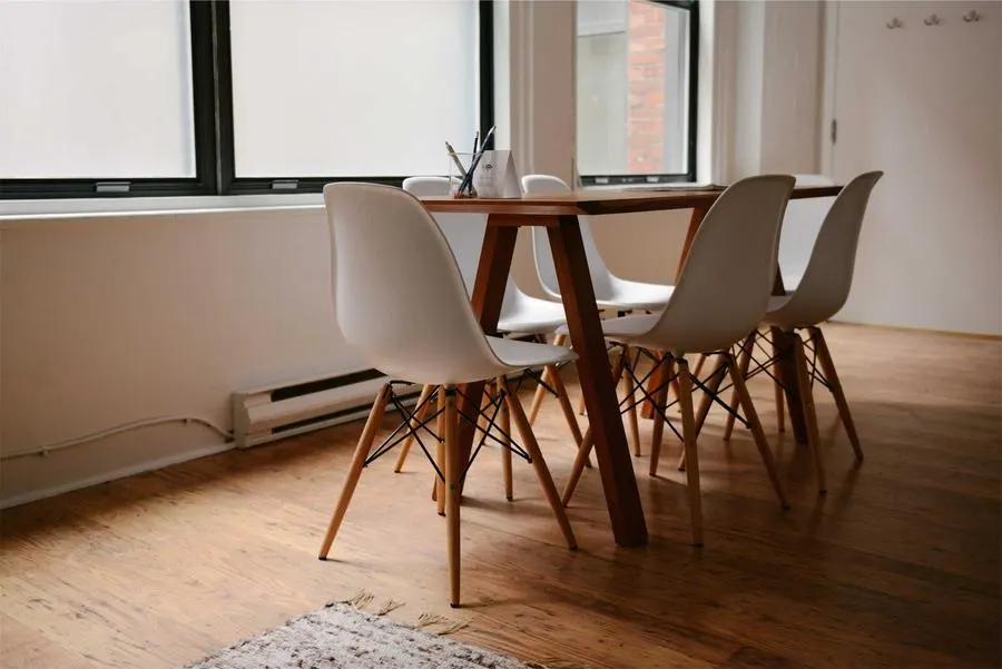 A bright renovated dining room with wooden table and chairs